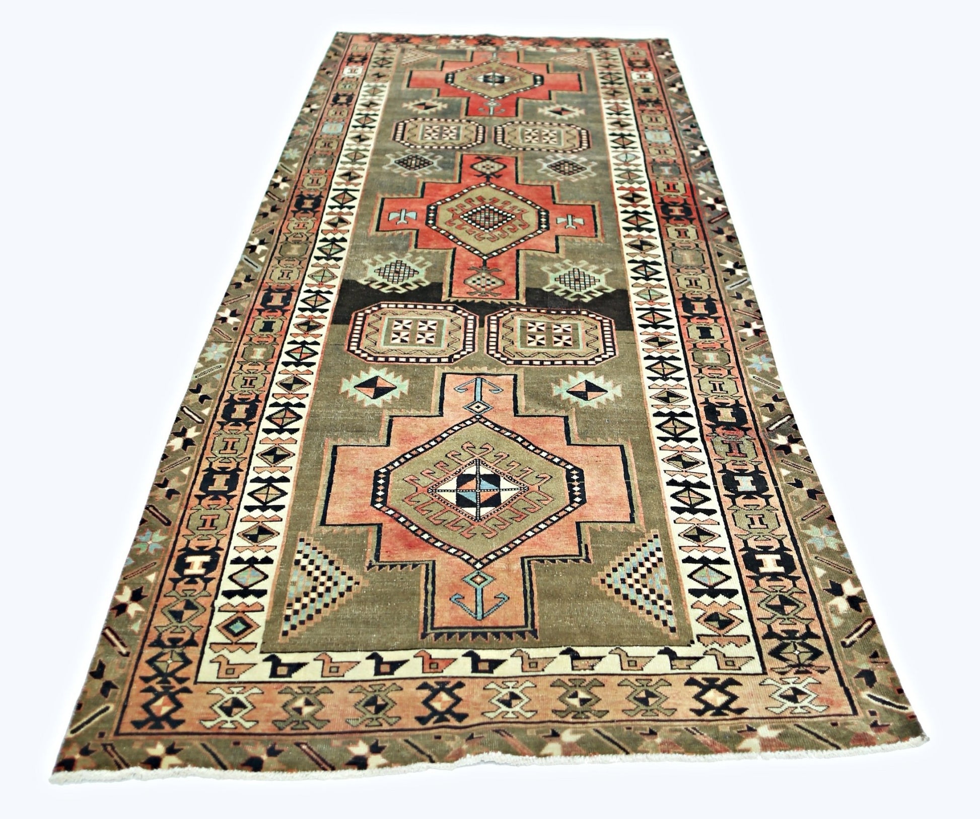 A vintage Persian Ardabil runner featuring geometric medallions in muted tones on a grey field.