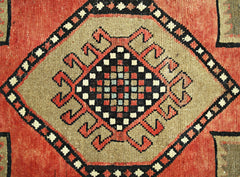 A vintage Persian Ardabil runner featuring a central geometric medallion with a checkered pattern.