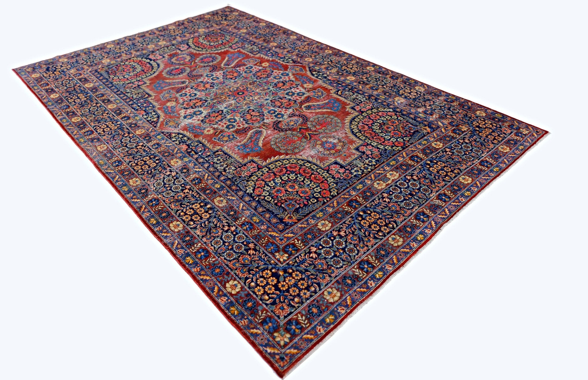 A vintage Persian Moud rug featuring a detailed floral pattern in red and blue tones.