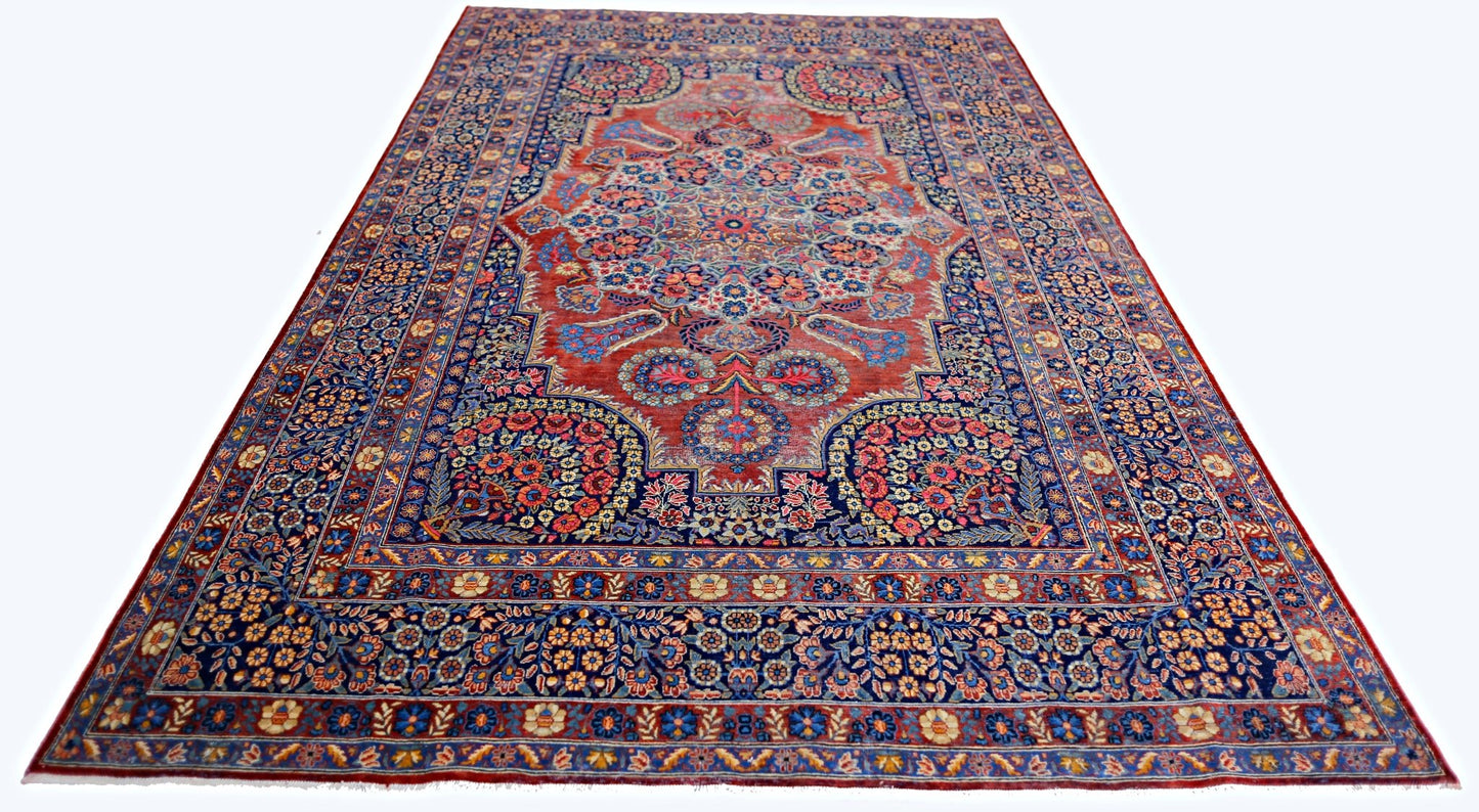 A vintage Persian Moud rug featuring a central floral medallion on a red field with blue borders.
