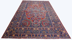 A vintage Persian Moud rug featuring a central floral medallion on a red field with blue borders.