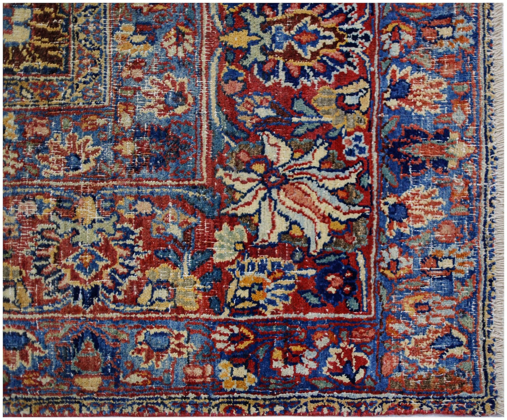 A vintage Persian Moud rug featuring a detailed floral pattern in red, blue, and cream tones.
