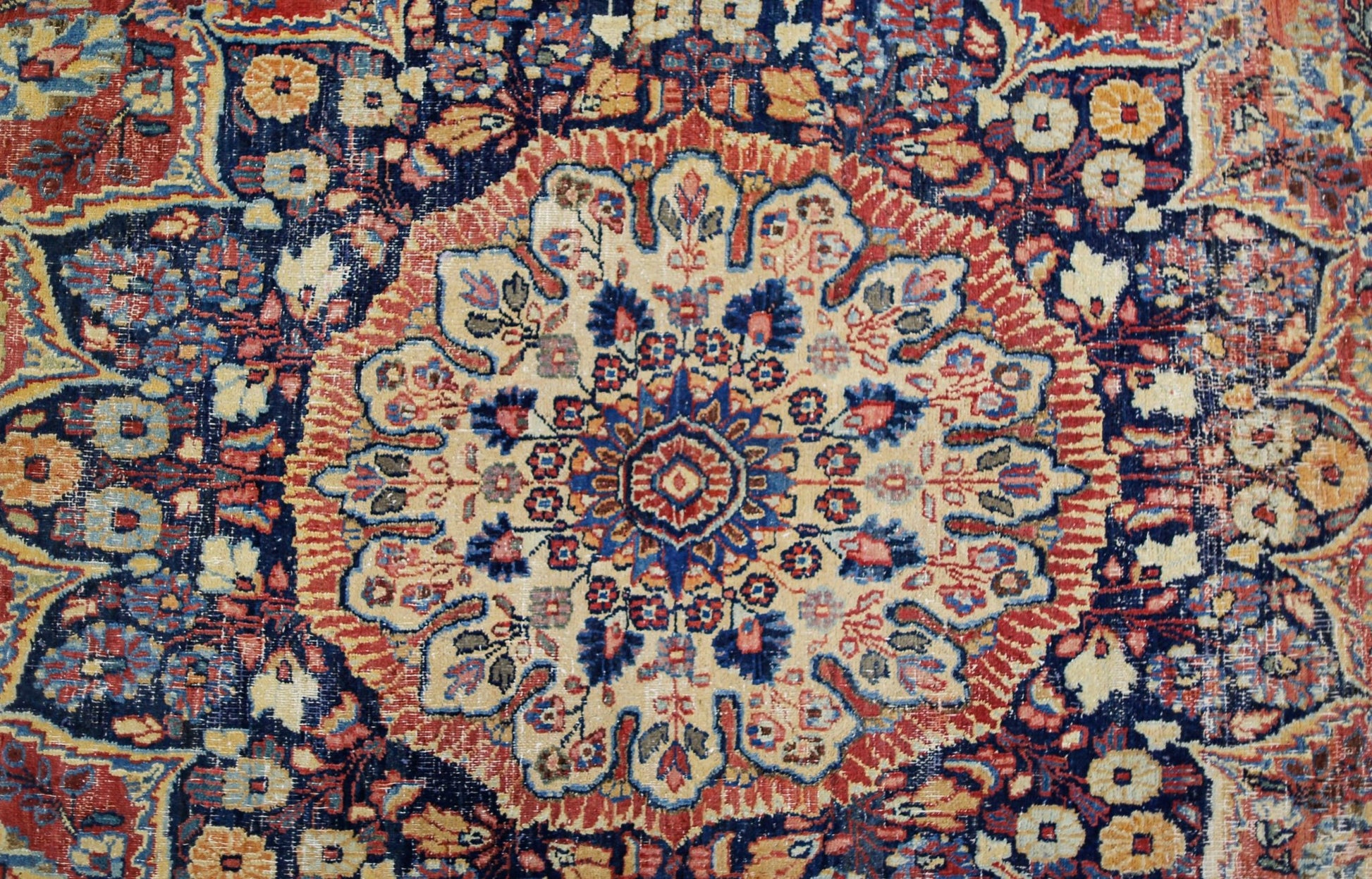 A vintage Persian Moud rug featuring a central floral medallion on a dark blue field.