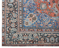 A vintage Persian Moud rug featuring intricate floral patterns in blue, red, and cream tones.