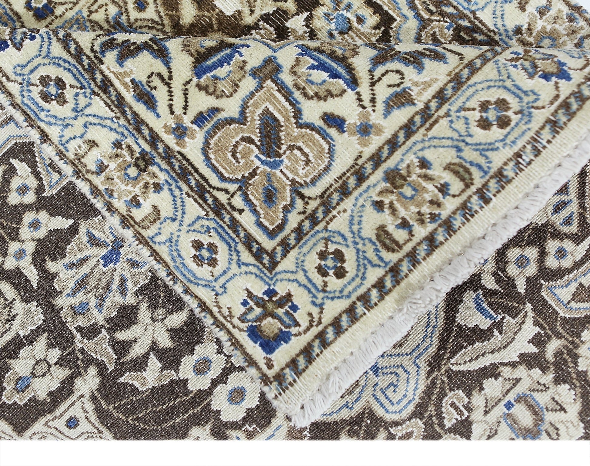 A vintage Persian Nain rug featuring intricate floral patterns in shades of blue, brown, and cream.