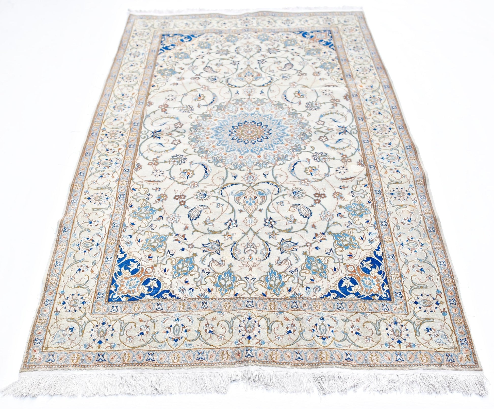 A vintage Persian Nain rug featuring an intricate blue and cream floral medallion design.