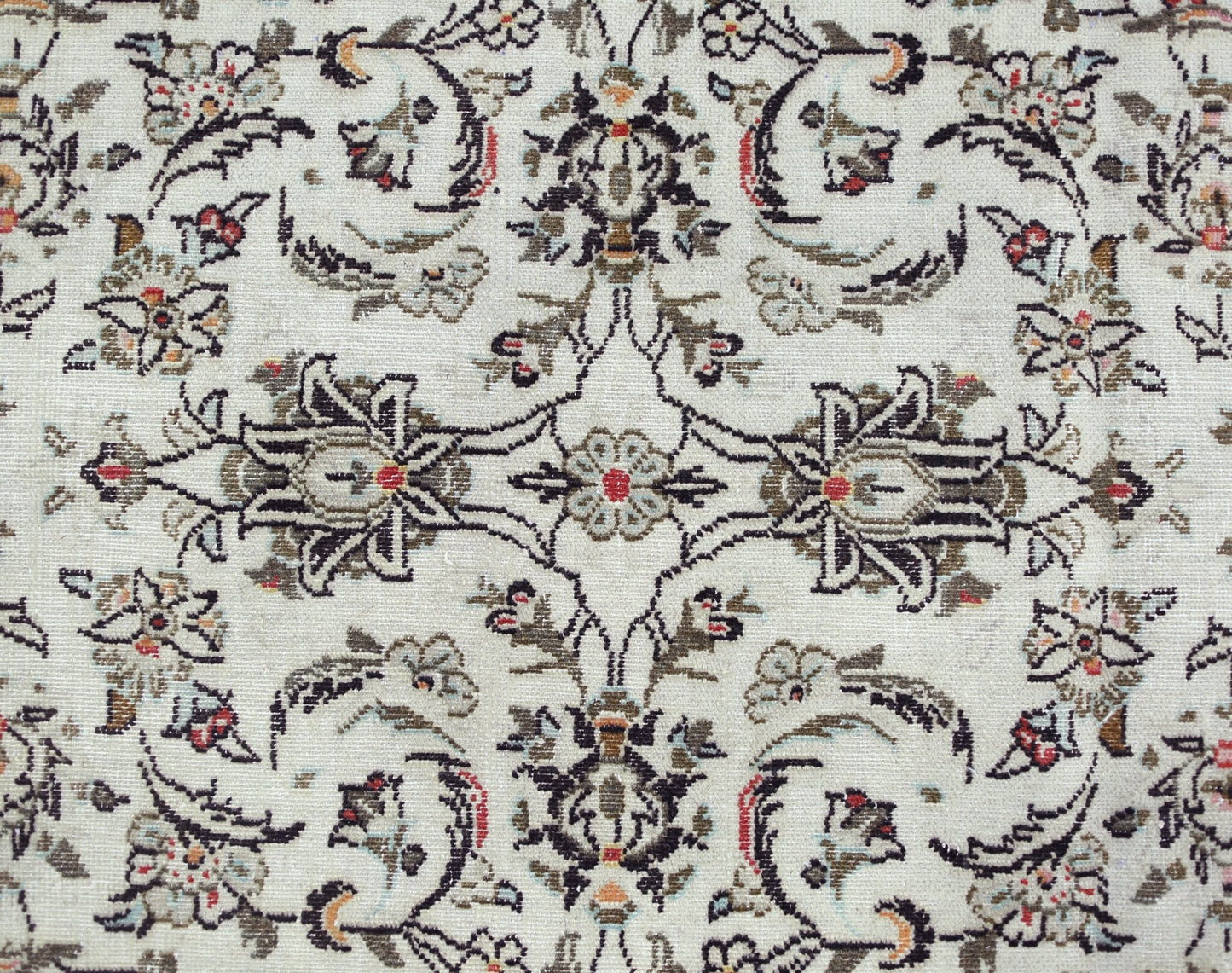 A vintage Persian Nain runner featuring an intricate floral pattern in muted tones on a cream base.