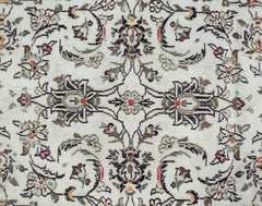 A vintage Persian Nain runner featuring an intricate floral pattern in muted tones on a cream base.