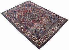 A vintage handwoven Persian Ghashghai rug featuring a traditional geometric pattern in red and blue.