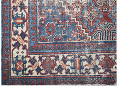 A vintage Persian Ghashghai rug featuring a geometric floral pattern in red, blue, and cream.