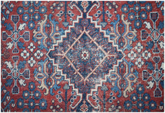 A vintage Persian Ghashghai rug featuring a geometric diamond pattern in red, blue, and cream.