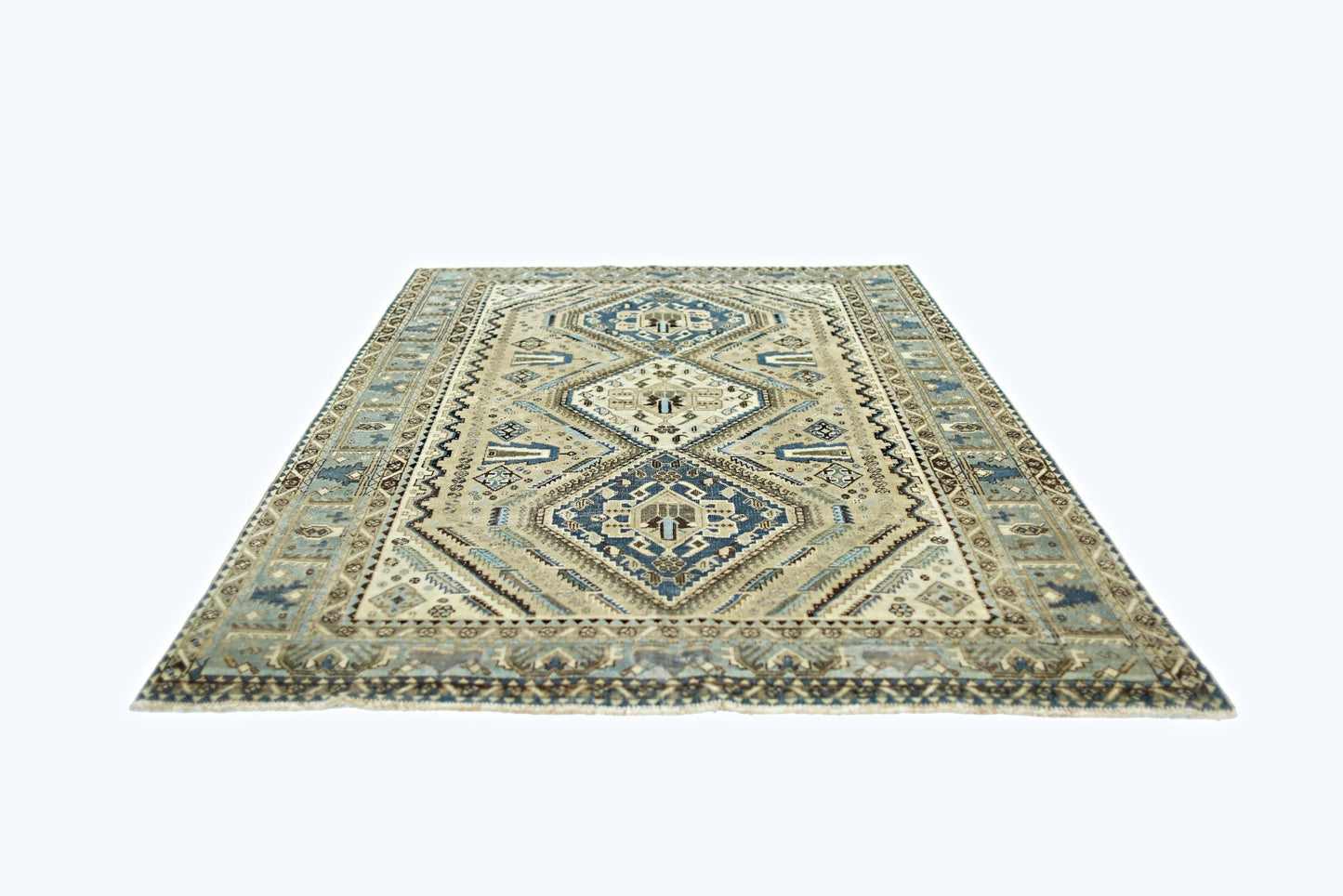 A vintage Persian Shiraz rug featuring a geometric diamond pattern in shades of blue and beige.