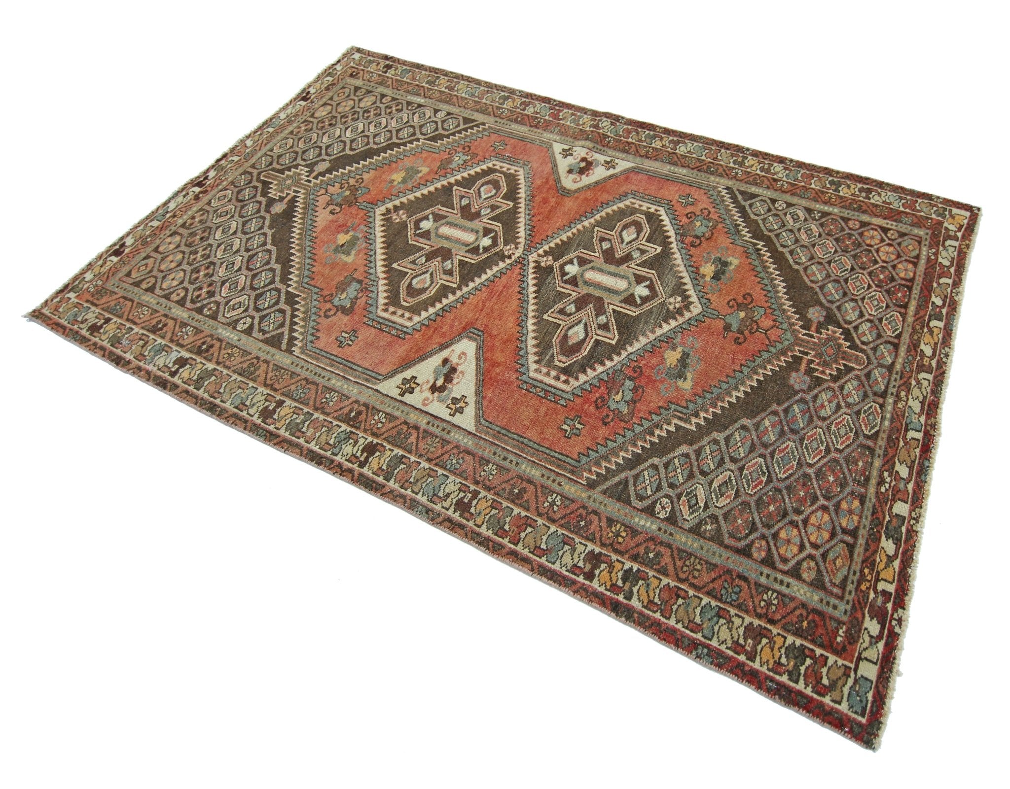 A handmade vintage Persian rug featuring geometric patterns in shades of brown and terracotta.