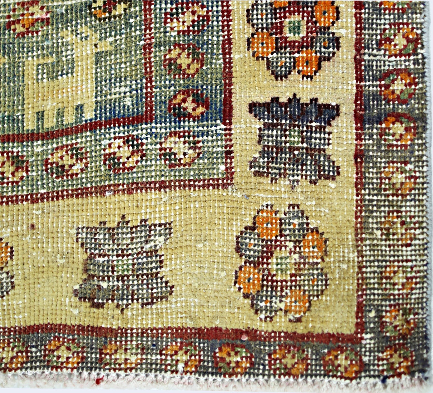 A close-up of a vintage Persian Qashqai rug featuring intricate geometric and floral patterns.