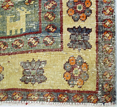 A close-up of a vintage Persian Qashqai rug featuring intricate geometric and floral patterns.