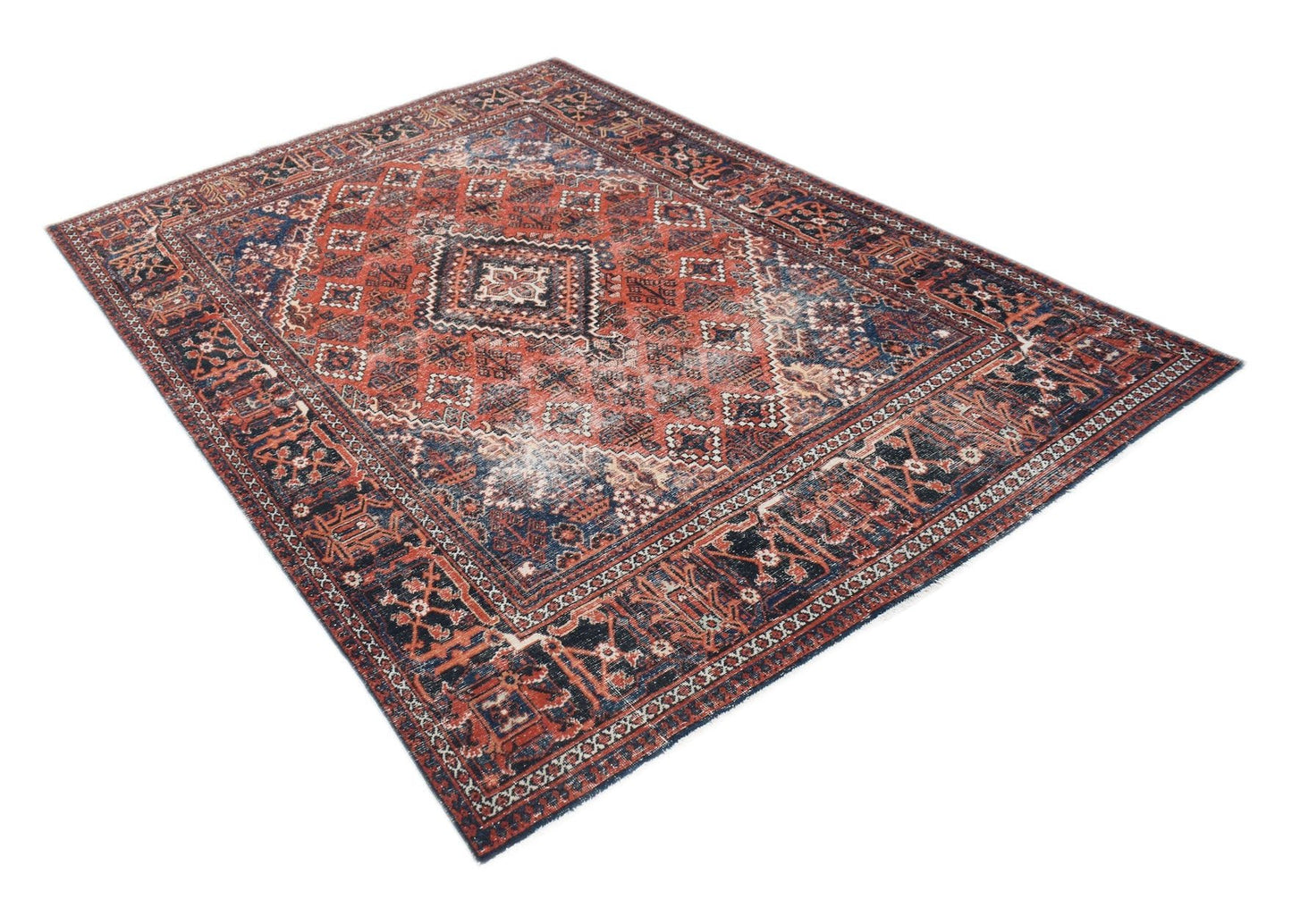 A vintage Persian Ghashghai rug featuring a geometric pattern in shades of red and navy blue.