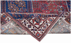 A handwoven vintage Persian Ghashghai rug featuring intricate geometric patterns in wool.