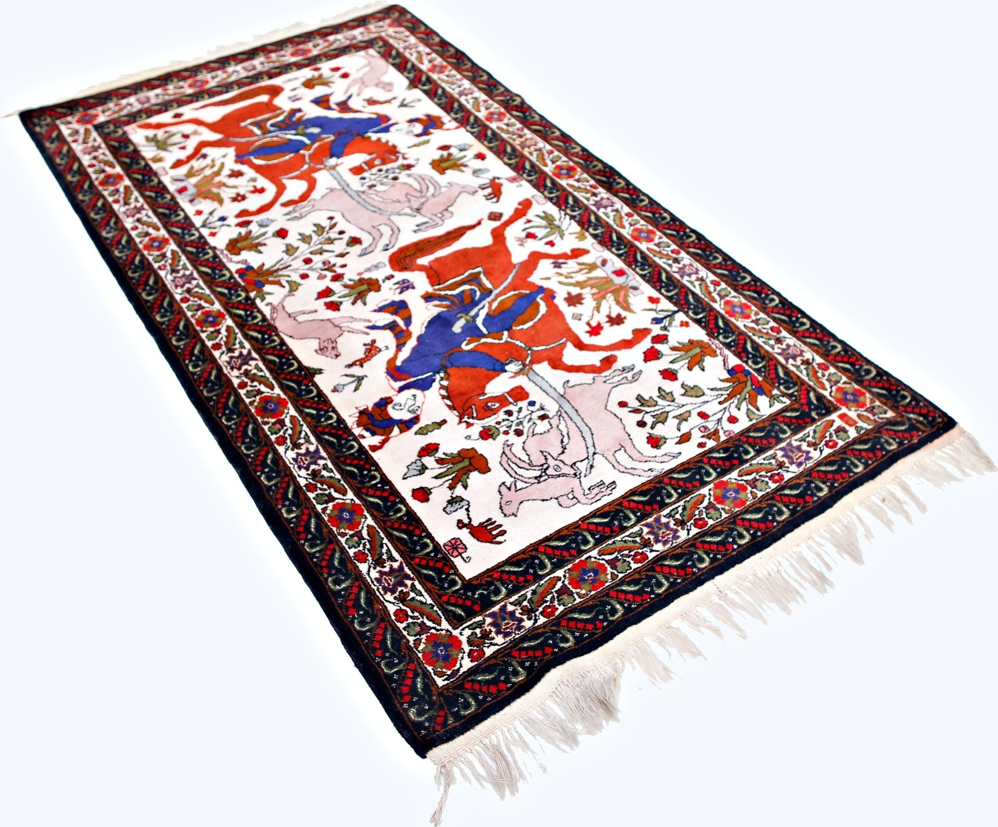 A vintage handmade Persian rug featuring a traditional hunting scene on a white background.