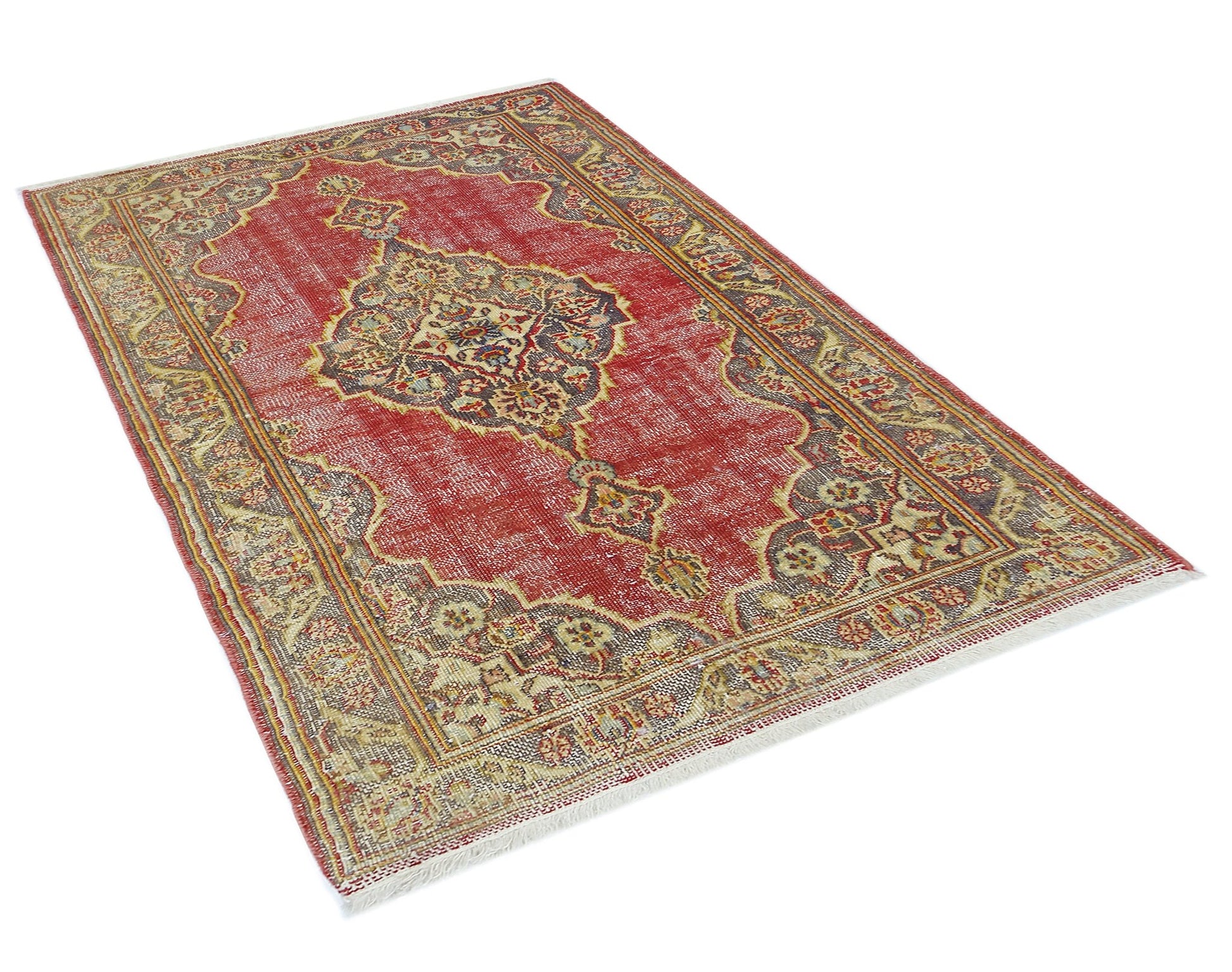 A vintage Persian rug featuring a central medallion pattern in red, beige, and dark grey tones.
