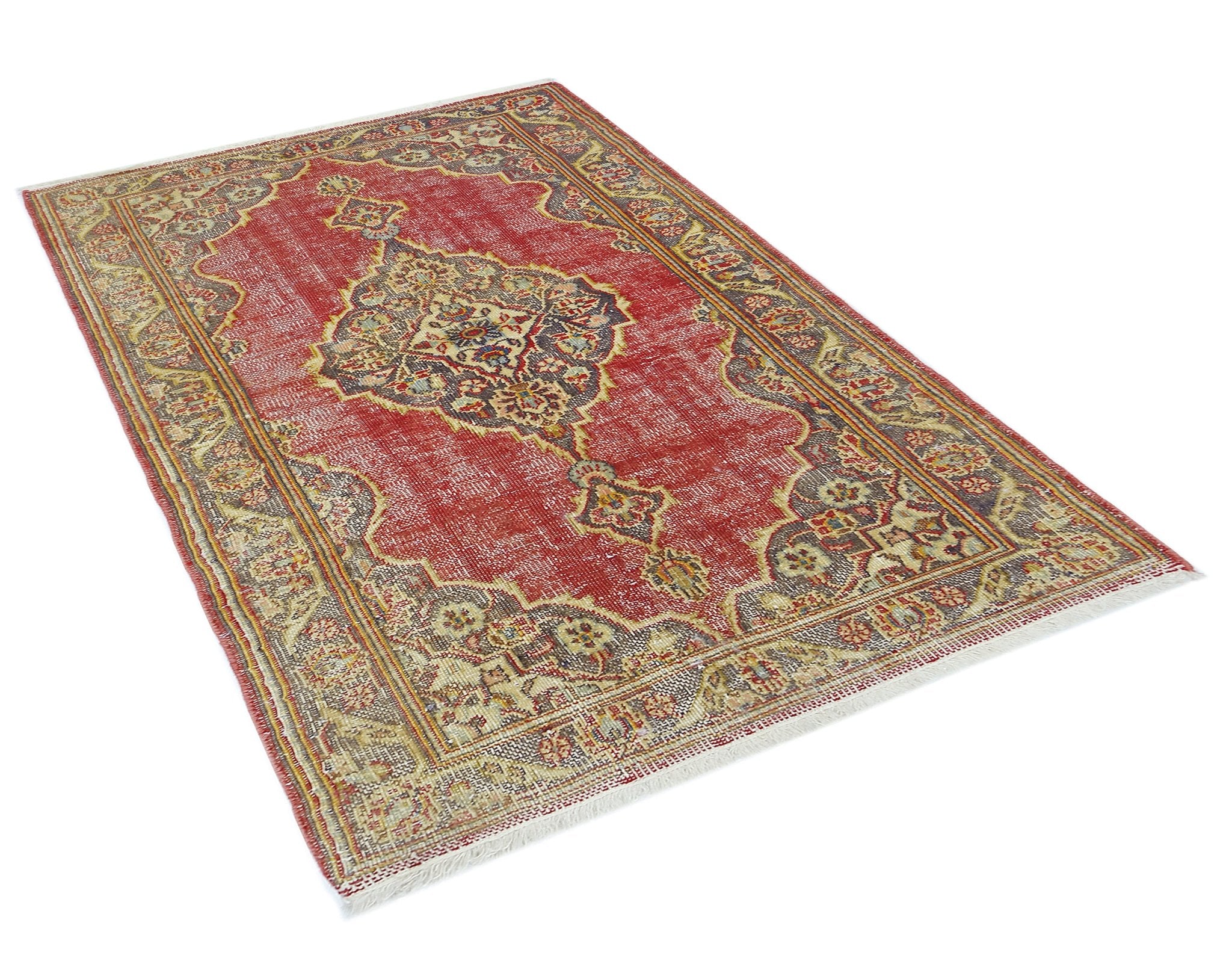 A vintage Persian rug featuring a central medallion pattern in red, beige, and dark grey tones.