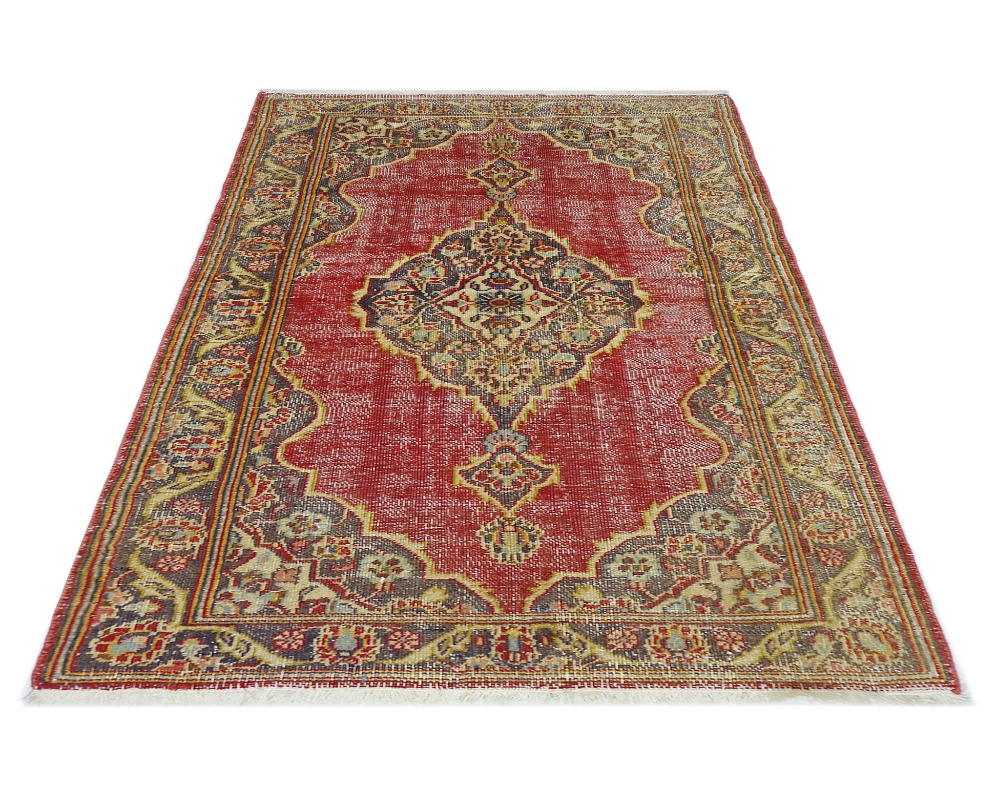 A vintage handmade Persian rug featuring a central medallion pattern in red, blue, and beige tones.