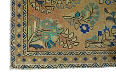 A vintage Persian rug featuring a floral pattern in blue and tan on an orange background.