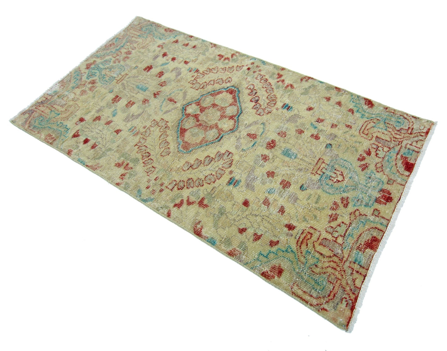 A vintage handmade Persian rug featuring a faded geometric pattern in red, blue, and beige tones.