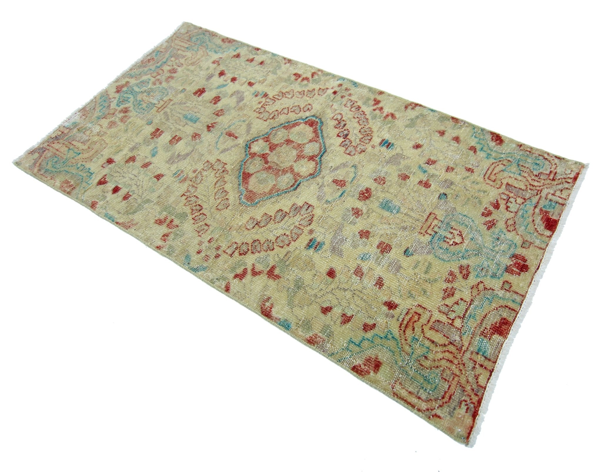 A vintage handmade Persian rug featuring a faded geometric pattern in red, blue, and beige tones.