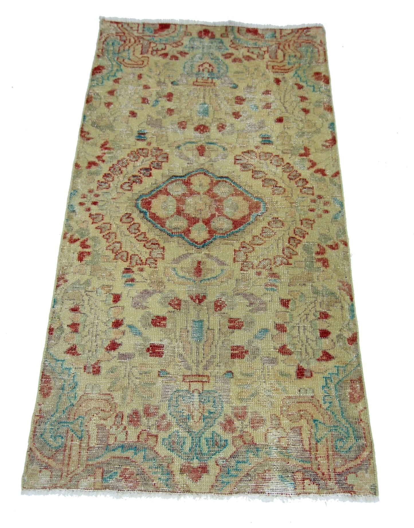 A vintage handmade Persian rug featuring a central medallion pattern in faded red and blue tones.