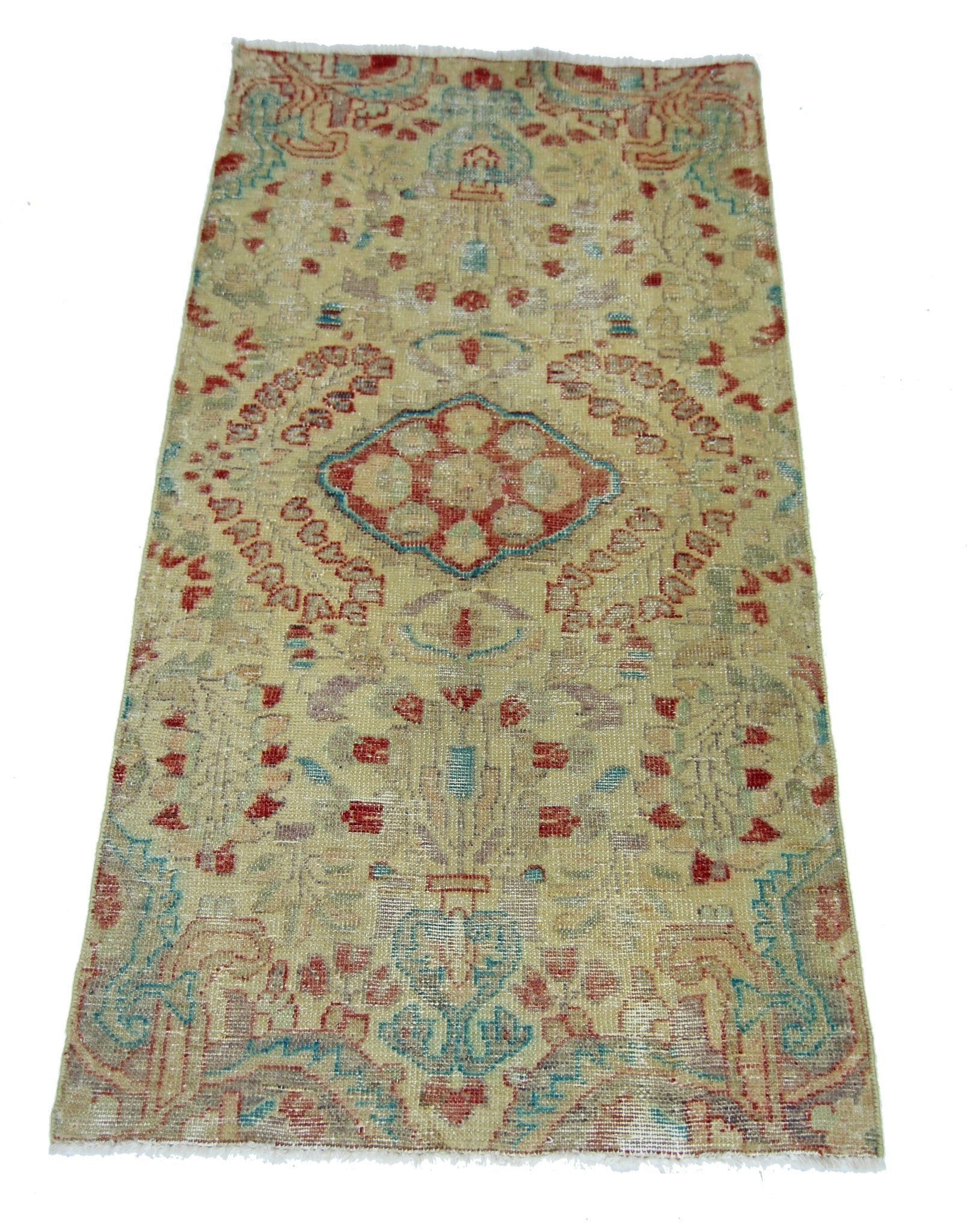 A vintage handmade Persian rug featuring a central medallion pattern in faded red and blue tones.
