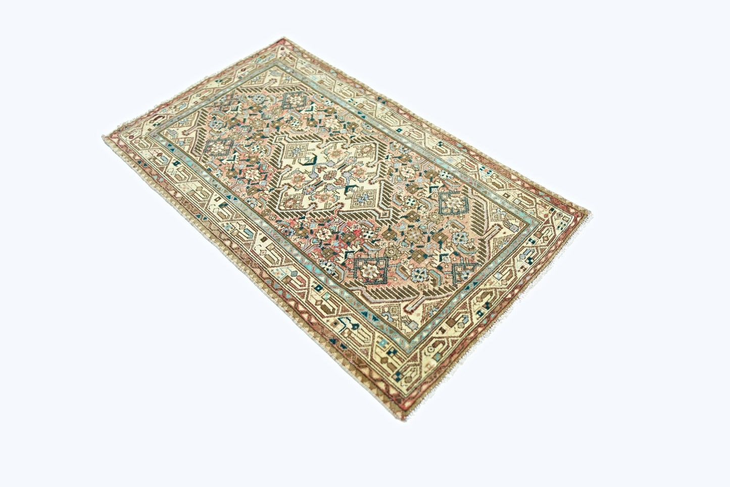 A rectangular vintage Persian rug featuring intricate geometric patterns in muted earth tones.