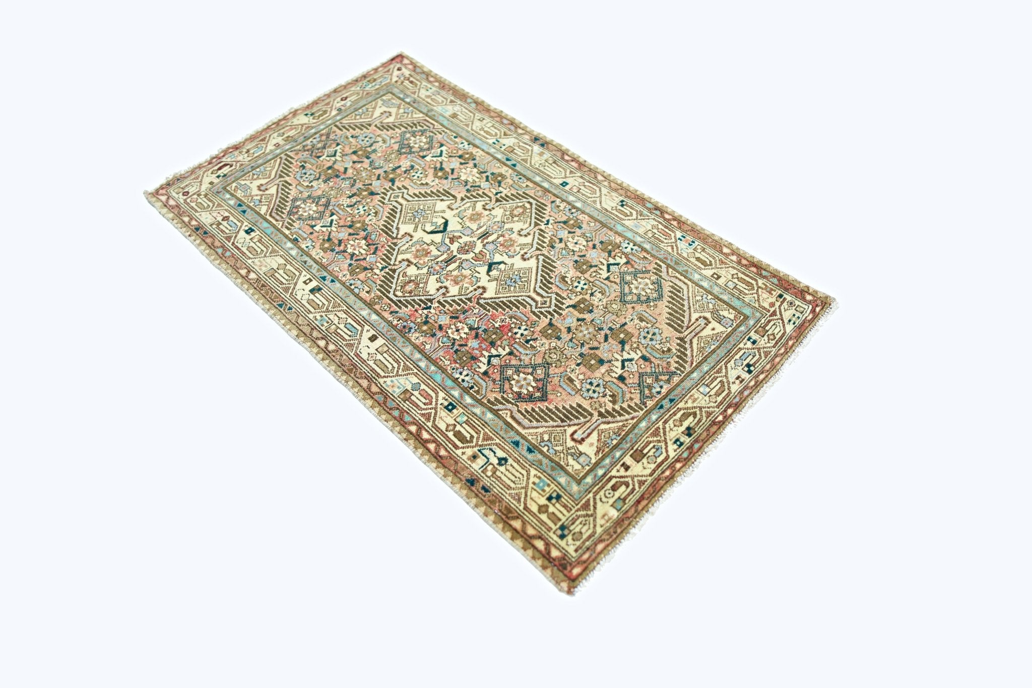 A rectangular vintage Persian rug featuring intricate geometric patterns in muted earth tones.