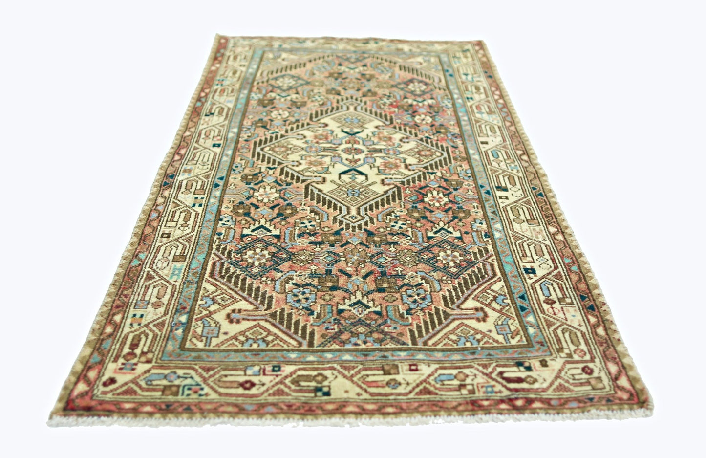 A rectangular vintage Persian rug featuring a geometric medallion pattern in muted earth tones.