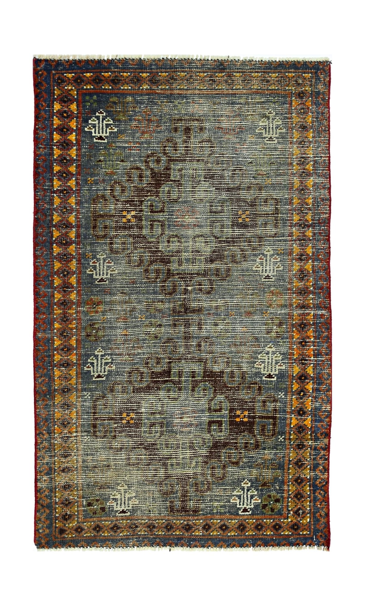 A vintage handmade Persian rug featuring a central geometric motif on a blue field.