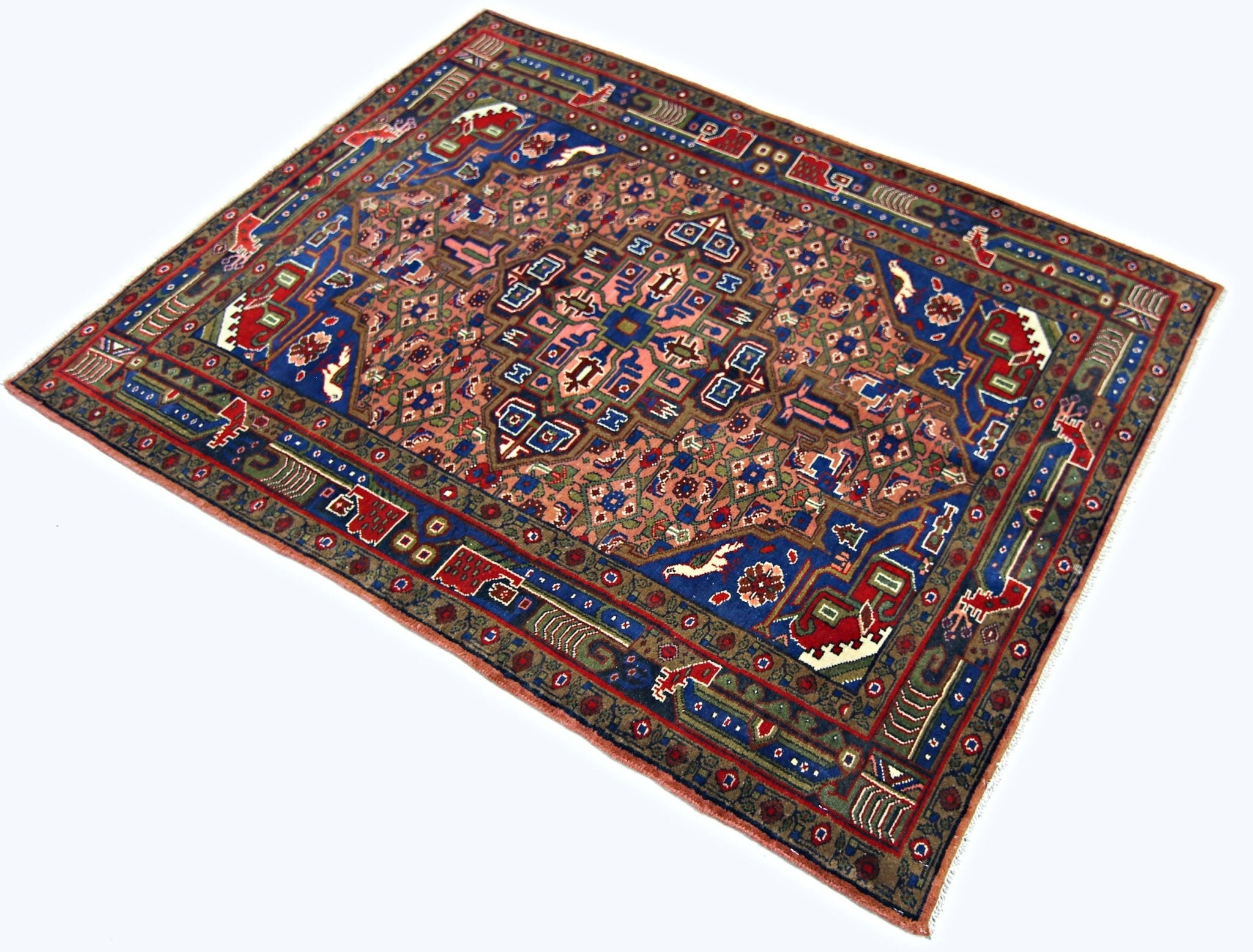 A rectangular vintage Persian rug featuring intricate geometric patterns in blue, red, and tan.