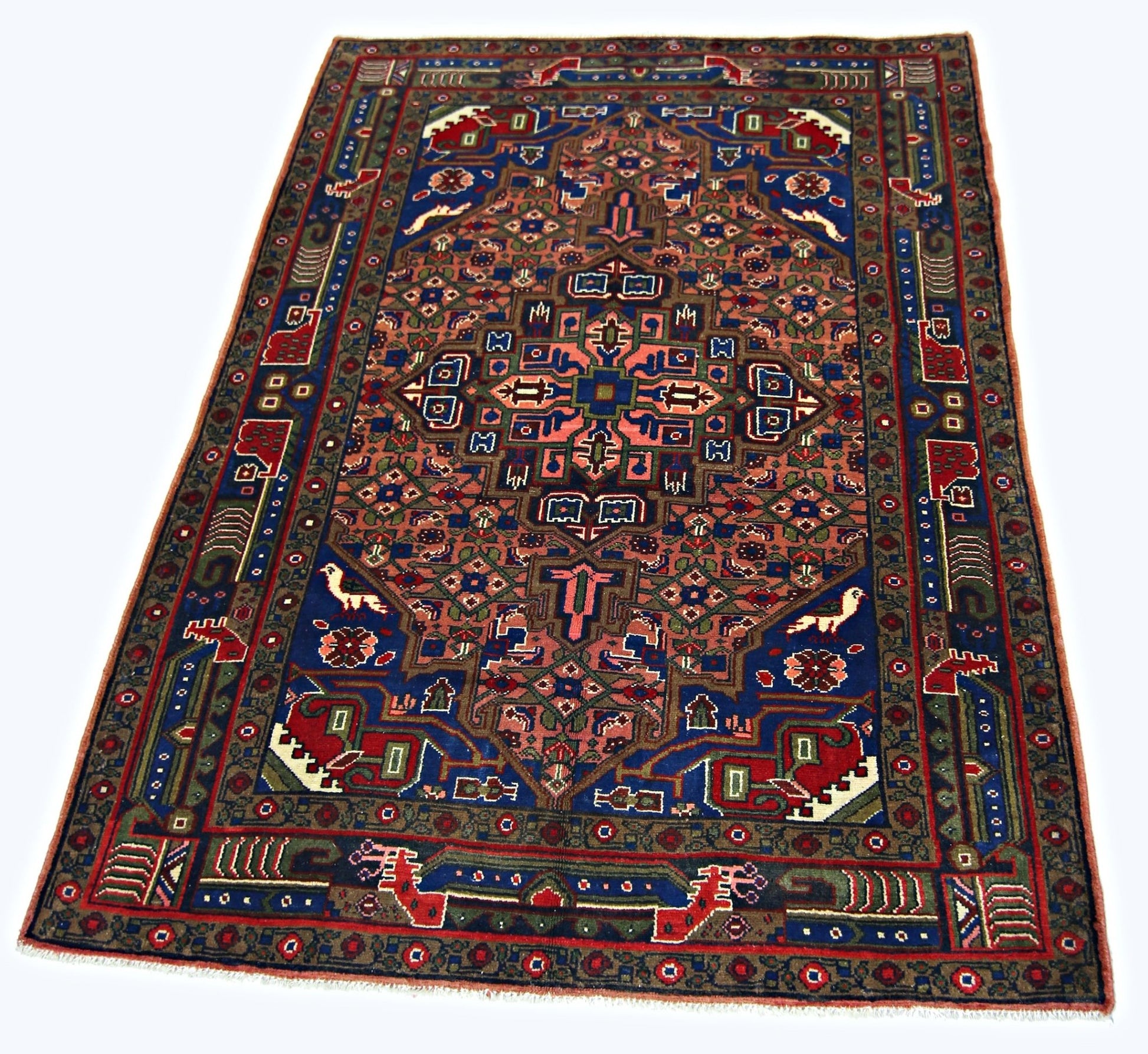 A rectangular vintage Persian rug featuring a geometric floral pattern in blue, red, and tan.