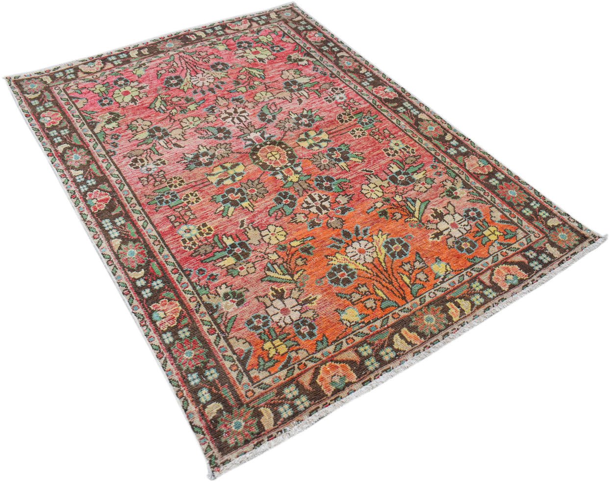A vintage handwoven Persian rug featuring a floral pattern in shades of red, orange, and brown.