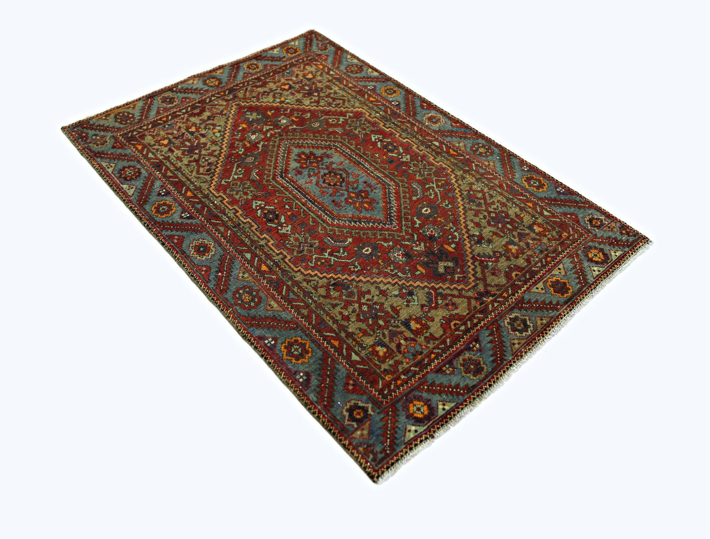 A rectangular vintage Persian rug featuring a central medallion and intricate geometric patterns.