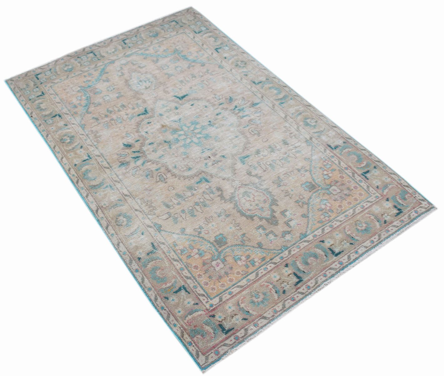 A vintage handwoven Persian rug featuring a faded floral pattern in soft blue and beige tones.