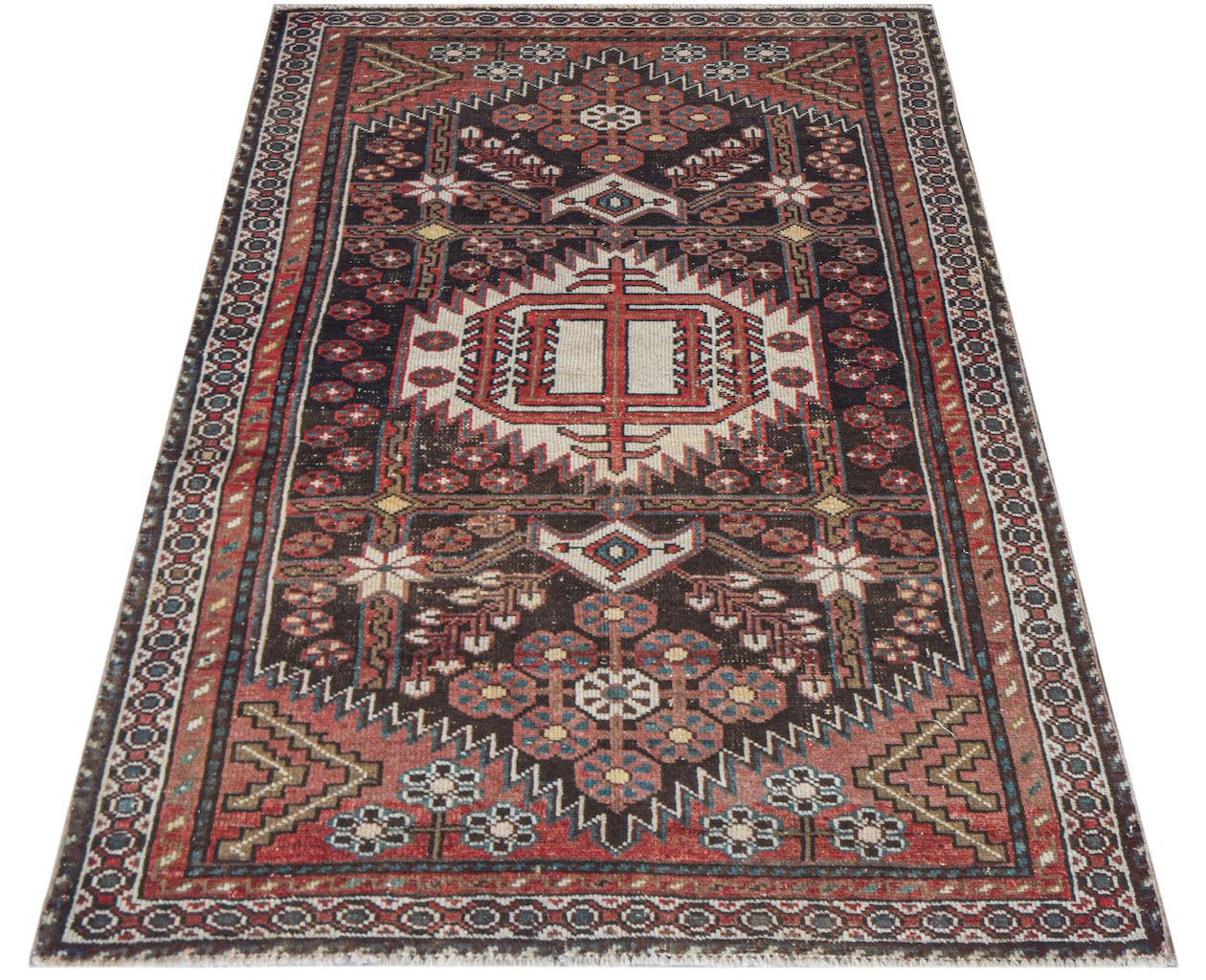 A handwoven vintage Persian rug featuring a geometric medallion pattern in red, brown, and cream.