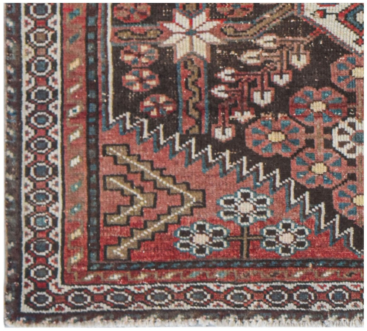 Vintage Persian rug with intricate geometric and floral patterns in red, brown, and blue.
