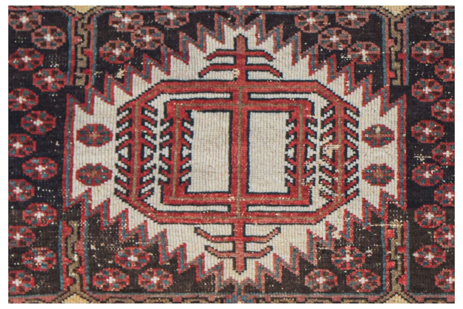 Vintage Persian rug with a central geometric medallion and floral motifs.
