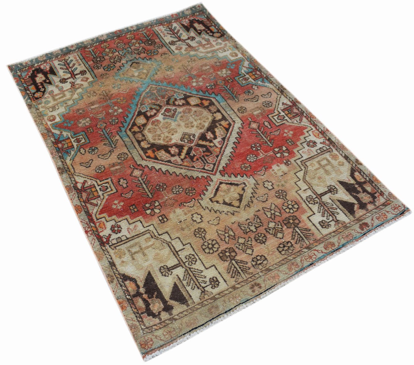 A handwoven vintage Persian rug featuring a central geometric medallion in red, blue, and beige.