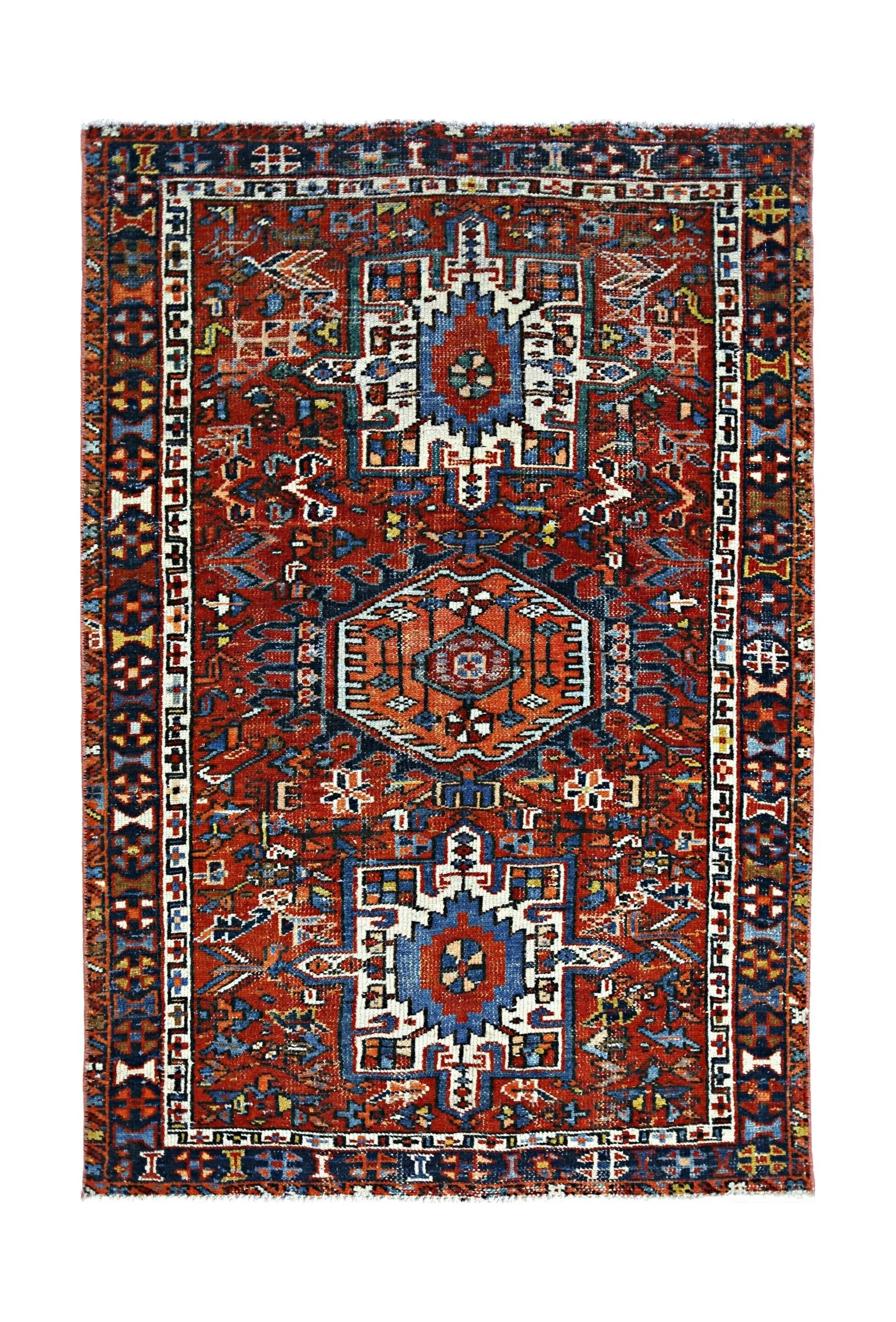 A rectangular vintage Persian rug featuring a geometric pattern in red, blue, and white.