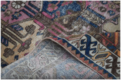 A handwoven vintage Persian rug featuring intricate geometric patterns in blue, pink, and brown.