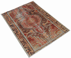 A rectangular vintage Persian rug featuring a geometric pattern in shades of red, brown, and cream.
