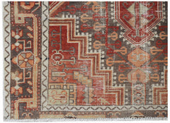 A handwoven vintage Persian rug featuring geometric patterns in shades of red, brown, and cream.