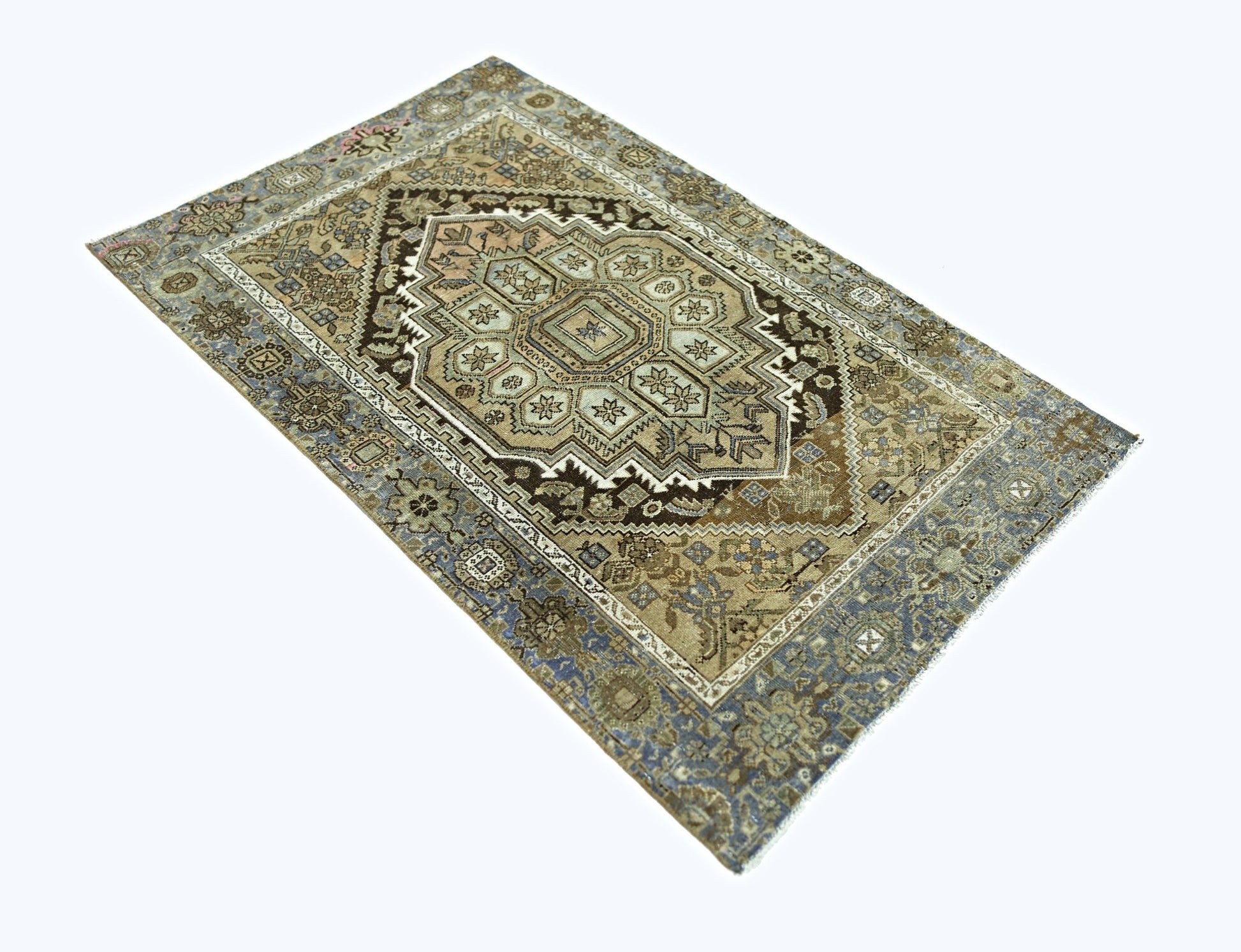 A rectangular vintage Persian rug featuring a geometric central medallion in muted earth tones.