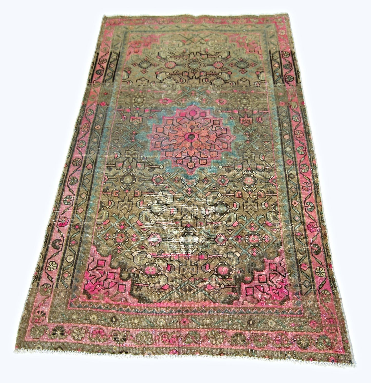 A rectangular vintage Persian rug featuring a geometric floral pattern in pink, blue, and brown.
