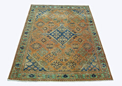 A rectangular vintage Persian rug featuring a central blue medallion on an orange field.